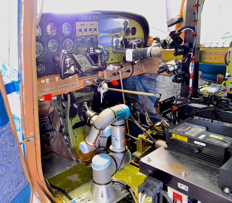 A Cockpit view of ROBOpilot attached to seat rails with no permanent modifications to the aircraft. Image Credit: US Air Force.