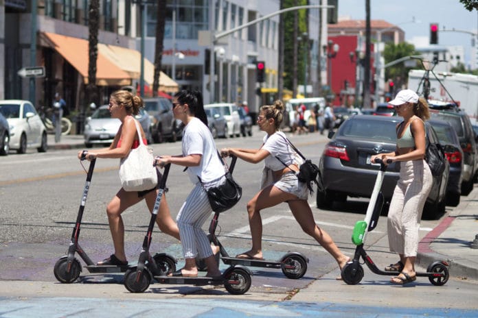 People using shared e-scooter