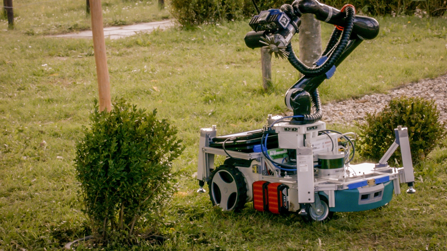 Trimbot robot trimming a bush.
