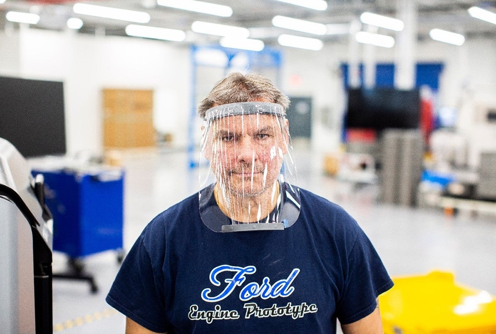 Dave Jacek, 3D printing technical, wears a prototype of a 3D-printed medical face shield printed at Ford.