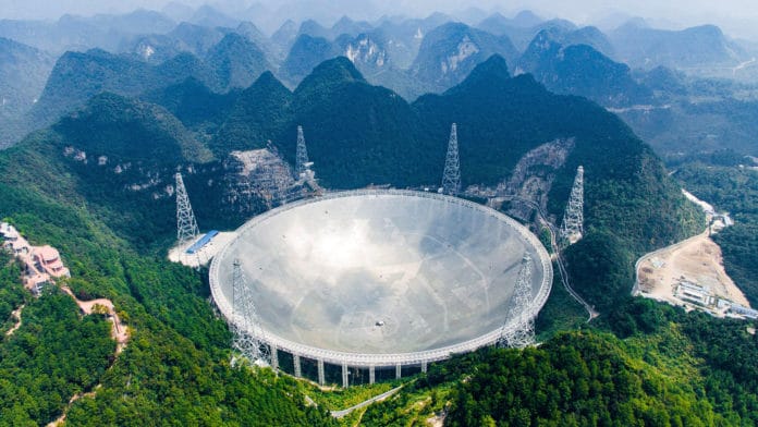 The giant FAST (Five-hundred-meter Aperture Spherical Telescope) radio telescope.