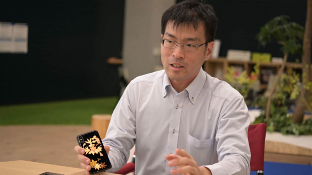 Shukichi Tanaka, Research Manager, with NeCycle cellphone.