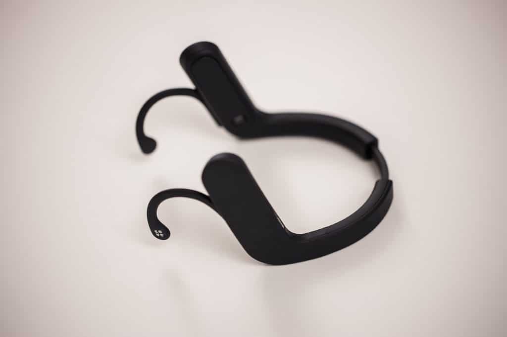 It is a neckband that hooks over your ears.