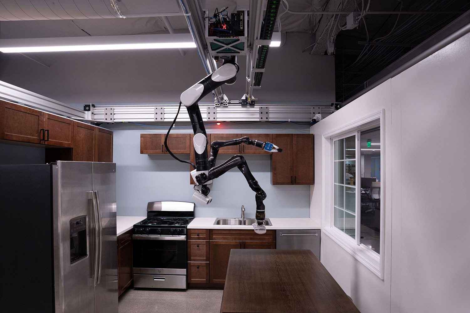 Toyota's Gantry robot hangs from the ceiling to perform household chores.