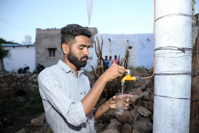 Madhu Vajrakarur taking drinking water