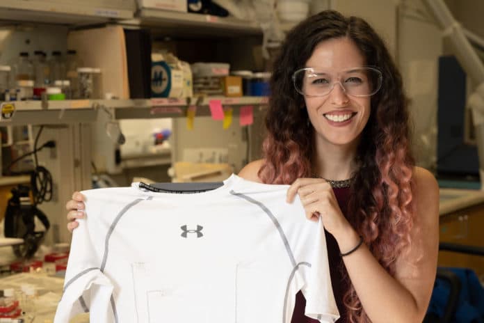 Rice University graduate student Lauren Taylor shows a shirt with carbon nanotube thread that provides constant monitoring of the wearer’s heart.
