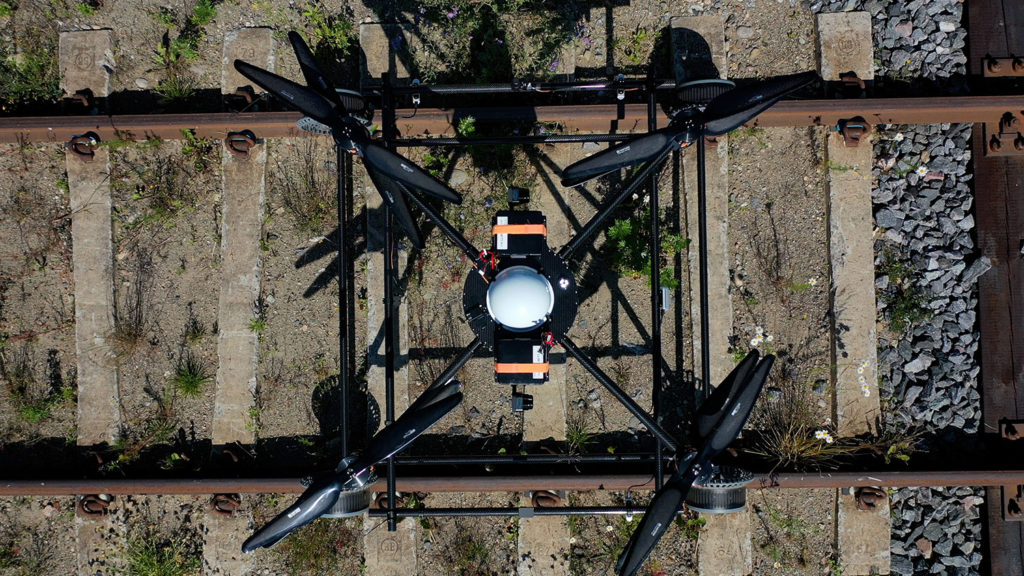 The railway drone will autonomously fly to the side of the track and let traffic pass.