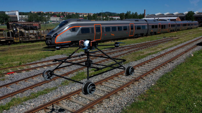 New rail-inspection robot can both fly and drive on the track.