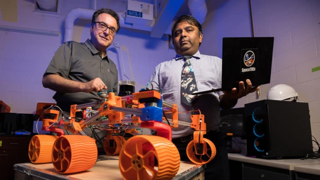 University of Arizona engineering faculty members Jekan Thanga (right) and Moe Momayez are pictured with a low-cost, rapidly designed, 3D-printed rover prototype used for testing a new generation of miniature sensors for applications in lunar mining.