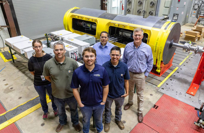NREL researchers Rebecca Fao, Mark Murphy, Casey Nichols, Andrew Simms, and Ismael Mendoza, along with C-Power CEO Reenst Lesemann, are pictured in front of the SeaRAY autonomous offshore power system at NREL’s Flatirons Campus.