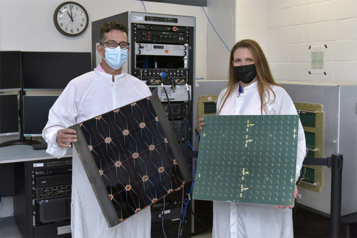 Project Managers James Winter (Air Force Research Laboratory) and Tara Theret (Northrop Grumman) hold models of the photovoltaic and the radio frequency sides of the sandwich tile.