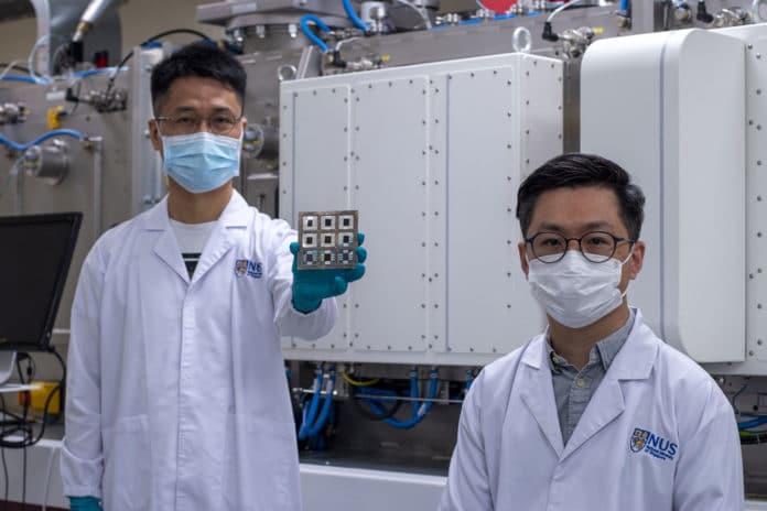 Asst Prof Hou Yi (right), Dr Chen Wei (left) and their team have developed perovskite/organic tandem solar cells (held by Dr Chen) that achieved a power conversion efficiency of 23.6%.
