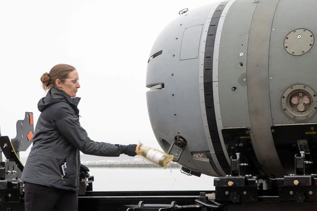 Cheryl Mierzwa, Division Newport’s technical program manager for Snakehead, christens the underwater vehicle at the Narragansett Bay Test Facility in Newport.