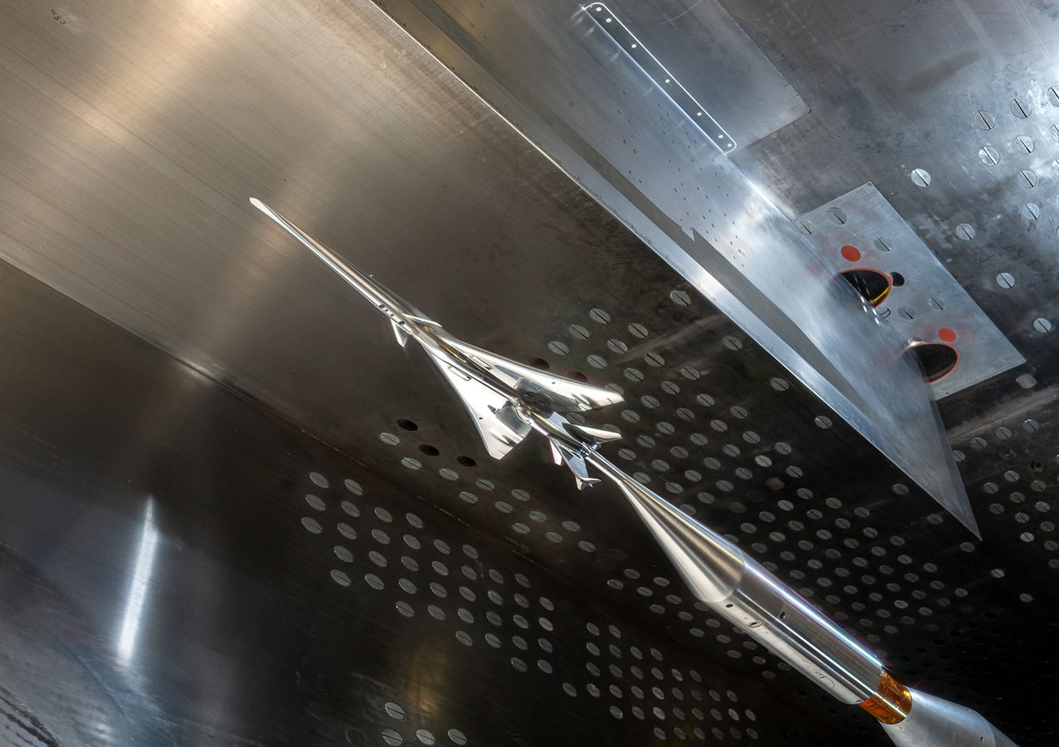 The X-59 small-scale model is seen in NASA Glenn’s 8- by- 6-foot Supersonic Wind Tunnel.