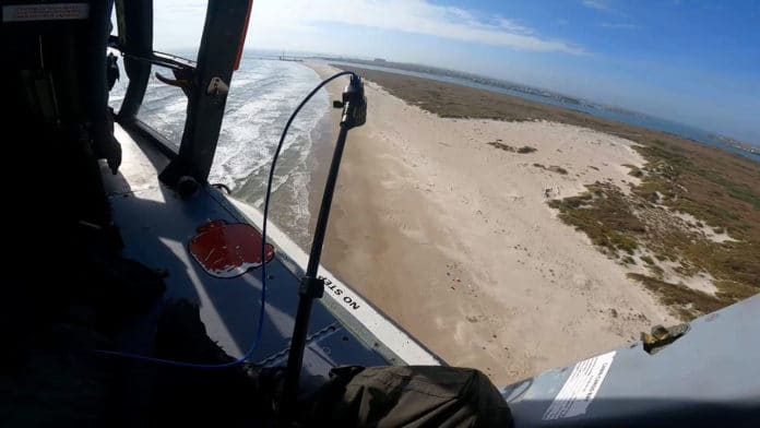 Testing polarimetric camera from U.S. Coast Guard helicopter over San Jose Island, Texas (Port Aransas in background), for future use in drones to detect marine debris along U.S. beaches.