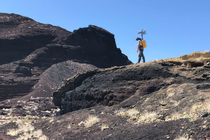 Michael Zanetti, a NASA planetary scientist at NASA’s Marshall Space Flight Center in Huntsville, Alabama, hikes the Cinder cone in Potrillo volcanic field in New Mexico in late 2021, testing the backpack-sized prototype for NASA's KNaCK.