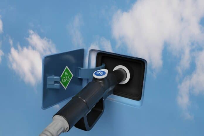 Fuel Dispenser With Hydrogen Logo on a blue sky 3d illustration.