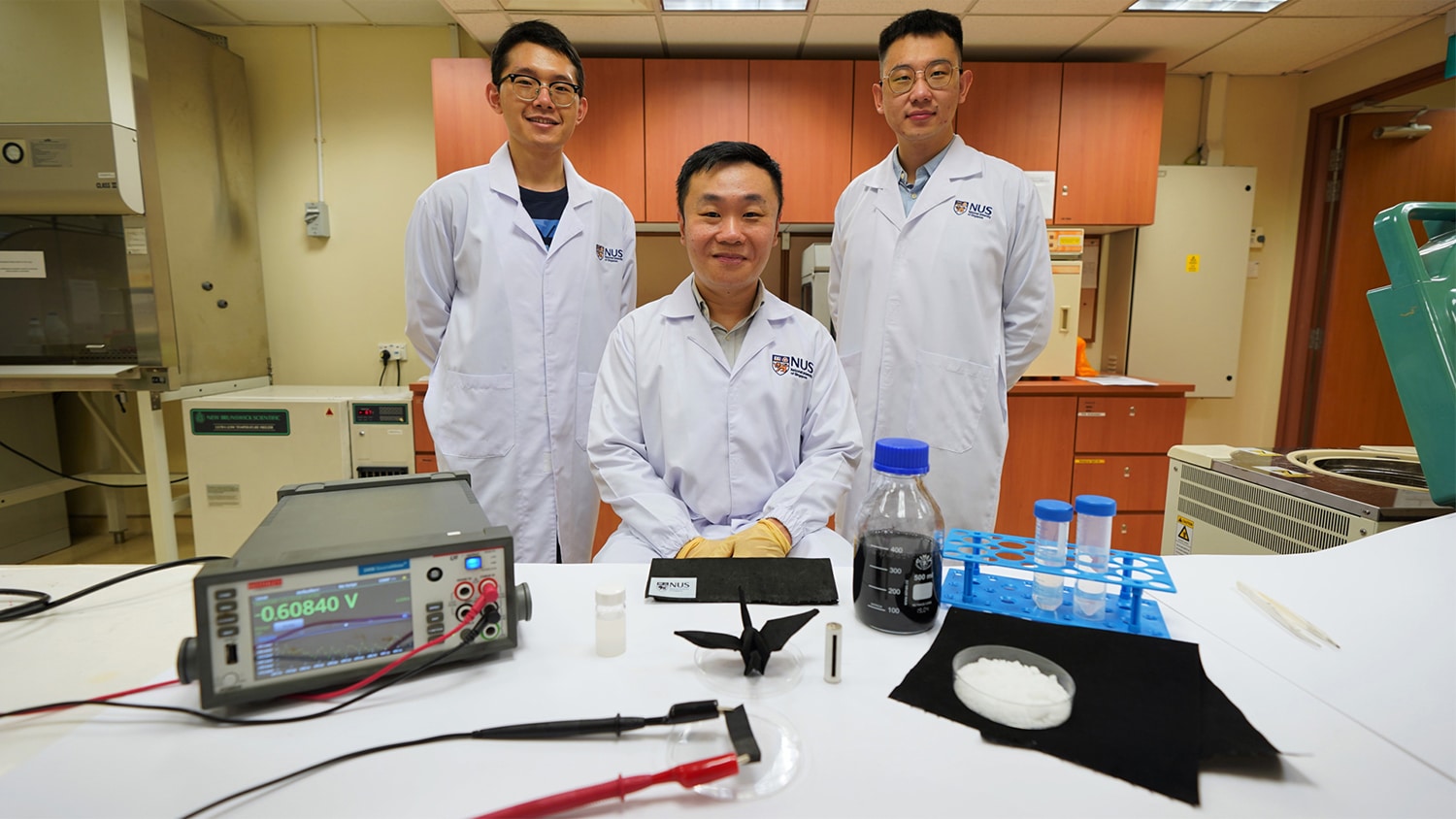 Asst Prof Tan Swee Ching (centre), together with Dr Zhang Yaoxin (left) and Mr Qu Hao (right), developed a self-charging fabric that generates electricity from air moisture.