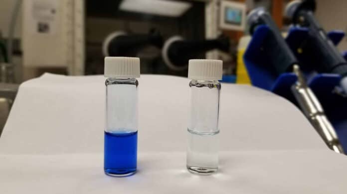 The left vial shows dye solution in water (blue) and the right vial shows clear water after the dye was removed from the solution by the polymer.