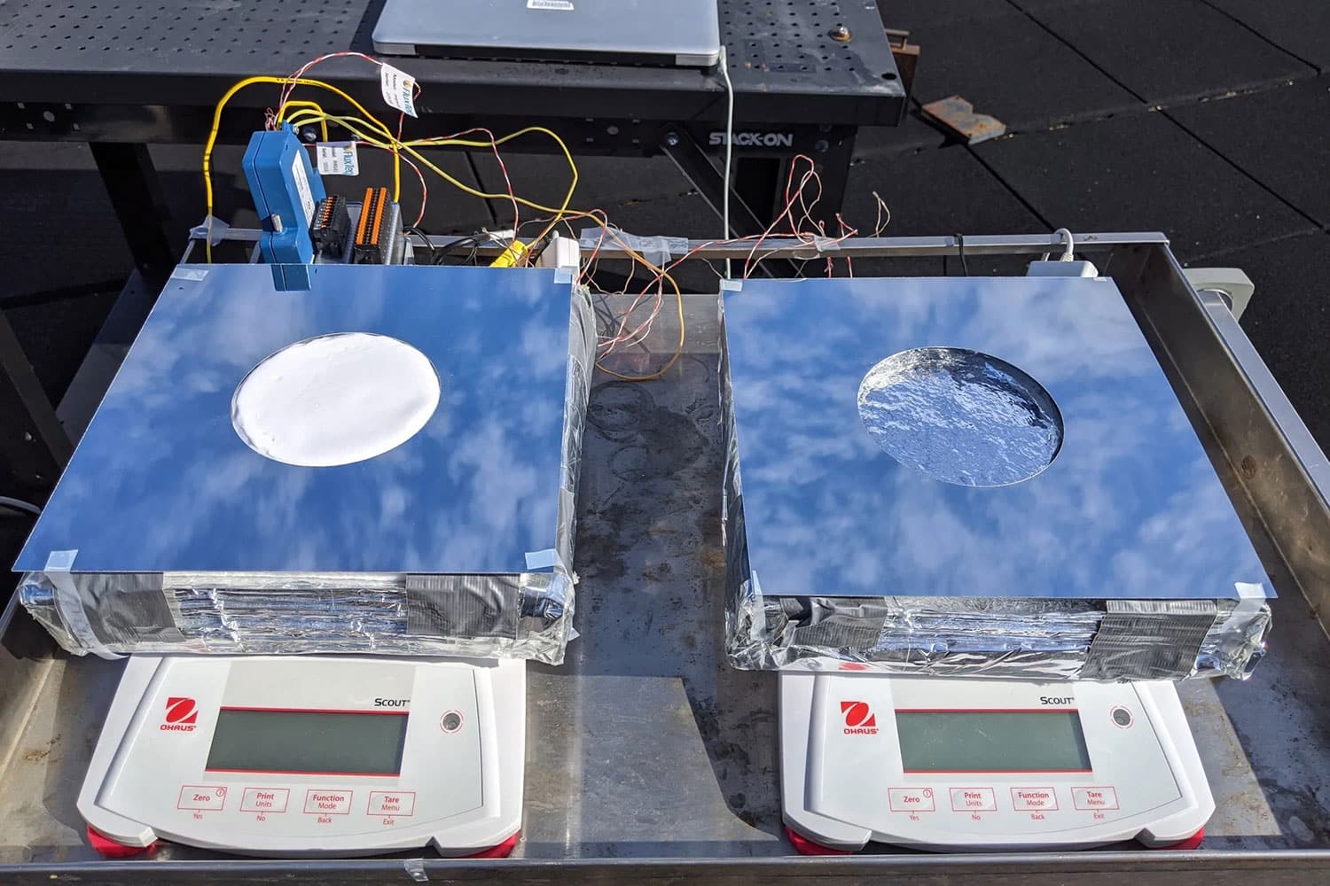 On the left, a sample of the new passive cooling system, combining evaporative cooling, radiative cooling, and insulation. On the right, a device using just evaporative cooling, for comparison testing.