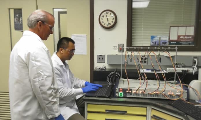 In this image, NASA researchers John Connell and Yi Lin (seated) are using a cyclic voltameter to check the performance level of a brand-new cathode the SABERS team created for their solid-state battery.