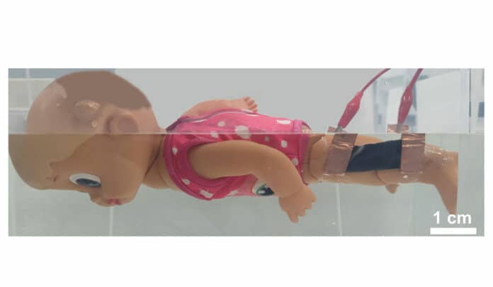 An underwater movement sensor attached to a motorized swimming doll's knee alerts a smartphone app when the doll stops kicking.