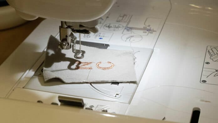 Yu Chen, graduate student at NC State, demonstrates embroidery techniques.