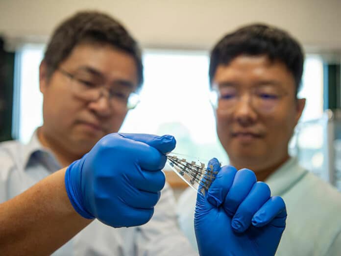 Researchers Cunjiang Yu (left), Dorothy Quiggle Career Development Associate Professor of Engineering Science and Mechanics (ESM), and ESM graduate student Hyunseok Shim demonstratting reconfigurable synaptic transistor.