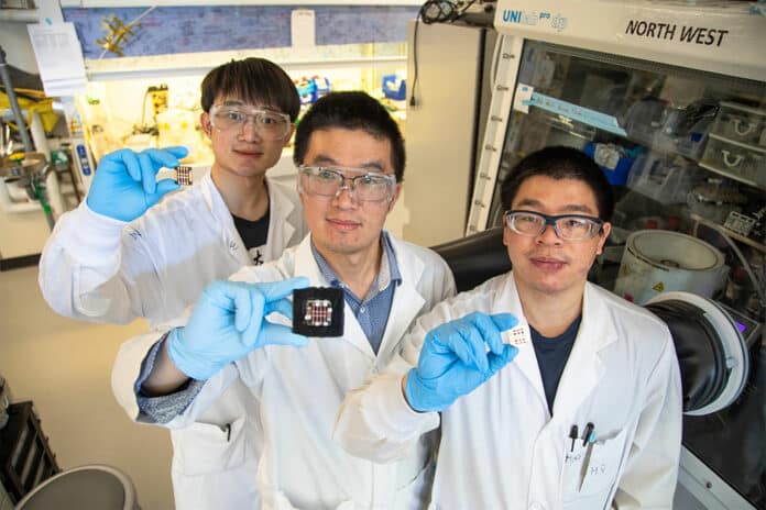From left Leiwei Zeng, Zaiwei Wang and Hao Chen show off samples of triple-junction perovskite solar cells that boast record gains in efficiency.