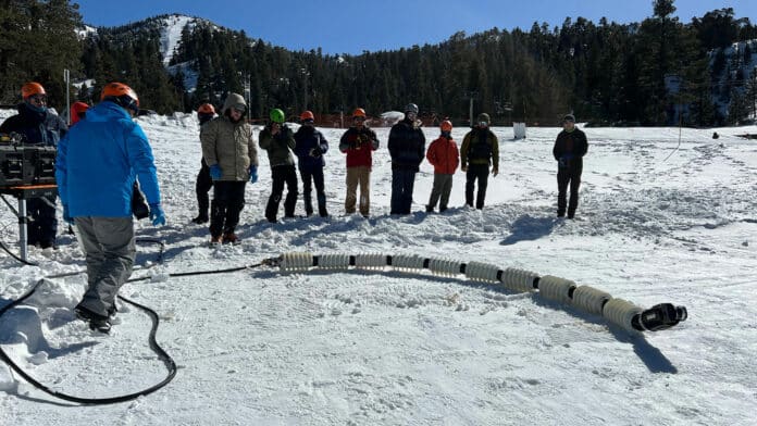 Team members from JPL test a snake robot called EELS at a ski resort in the Southern California mountains in February.