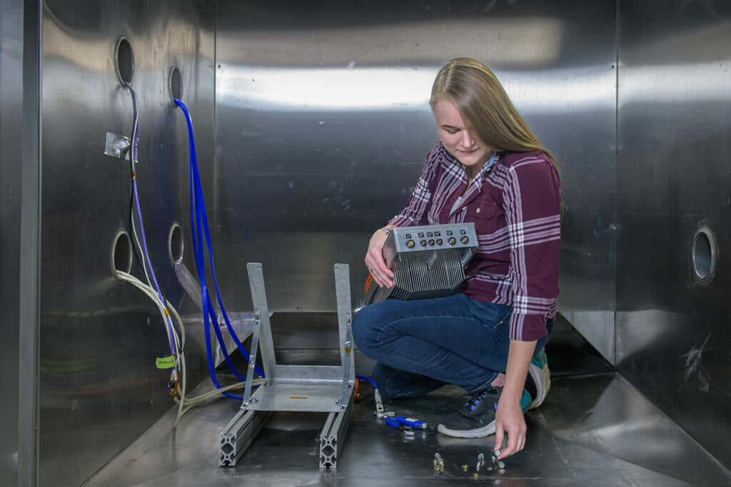 NASA Glenn’s Susanah Kowalewski prepares a cruise motor controller for testing.