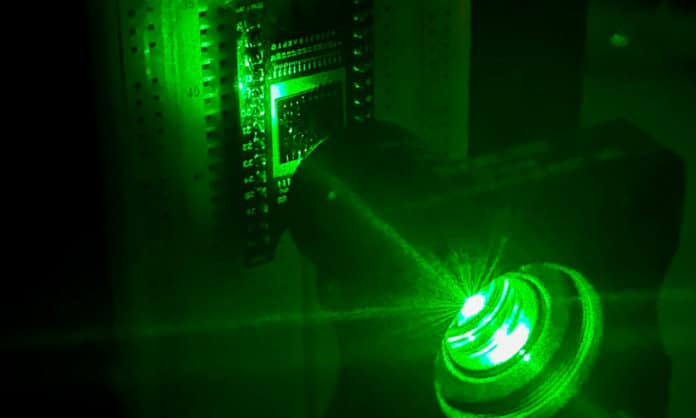 The neuromorphic vision chip (left) in a demonstration (in visible light) of the team's experiment, which used ultraviolet light.