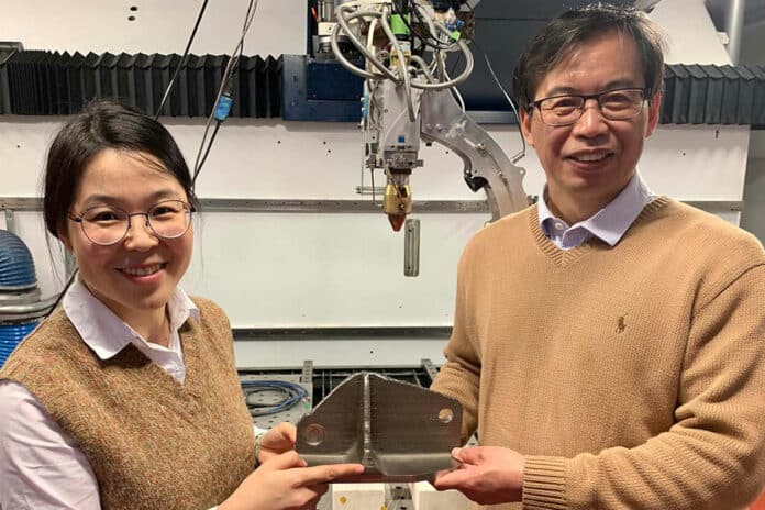 Team members Dr Tingting Song and Professor Ma Qian (left to right) with a titanium alloy part created with the laser 3D printer that the team used at RMIT University. (Note: this is not an alloy part that the team made for this research.)