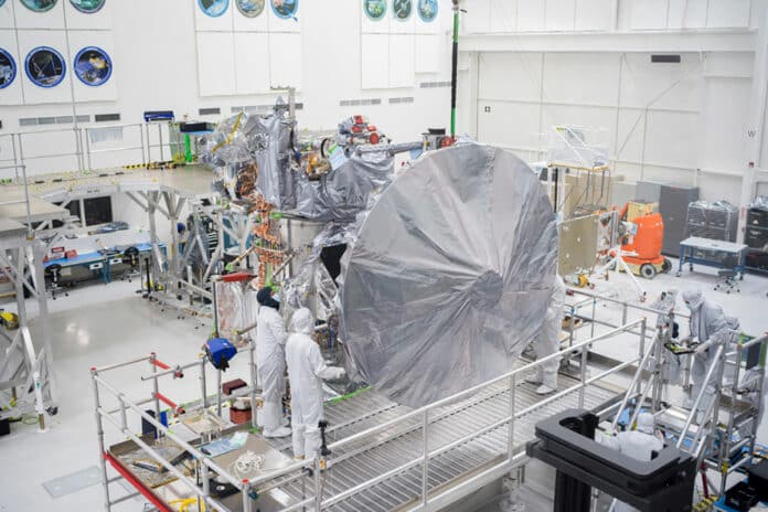 Engineers and technicians install Europa Clipper’s high-gain antenna in the main clean room at JPL.