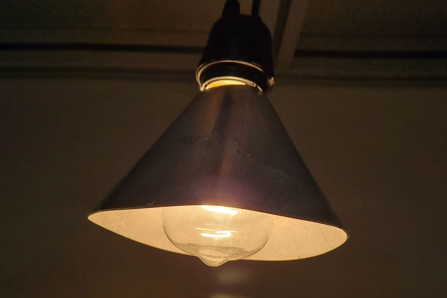 A lampshade coated with a catalyst uses heat from an incandescent bulb to destroy indoor air pollution.