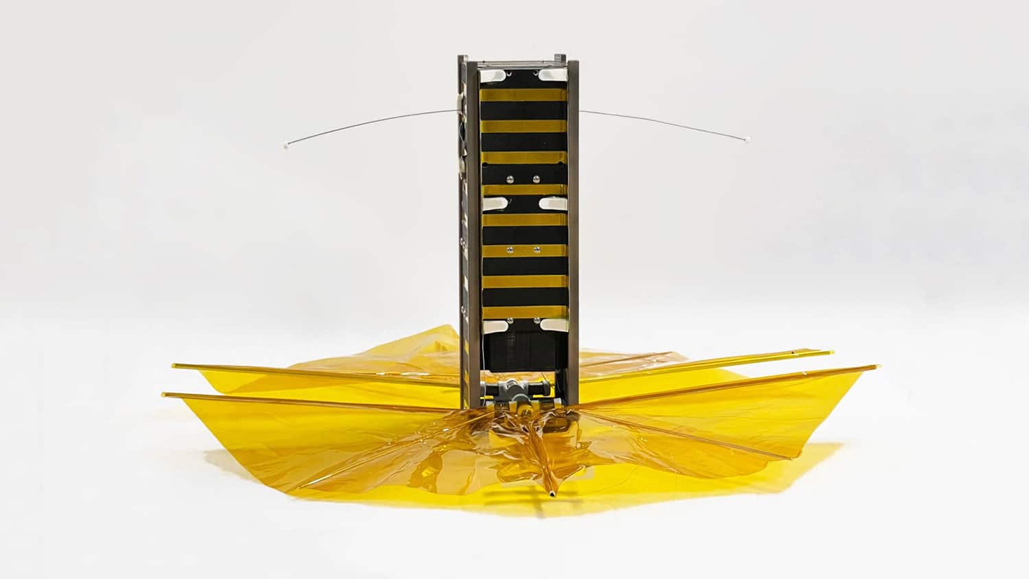 SBUDNIC, a bread-loaf-sized cube satellite with a drag sail made from Kapton polyimide film.
