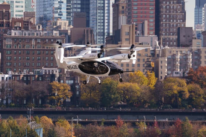 Joby’s electric air taxi in the skies above New York City, piloted by James “Buddy” Denham.