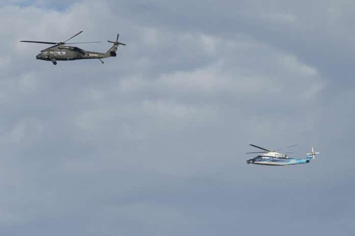 NASA pilots along with Sikorsky safety pilots flying Sikorsky’s Black Hawk Optionally Piloted Vehicle, left, and SARA S-76B over Long Island Sound Thursday, Oct. 26, 2023.