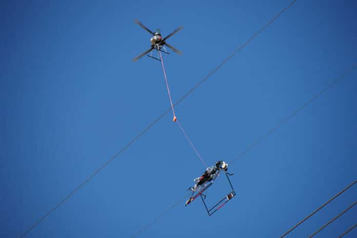 Utility lineworkers utilize the Mini LineFly to install PLP BIRD-FLIGHT Diverters on overhead power lines.