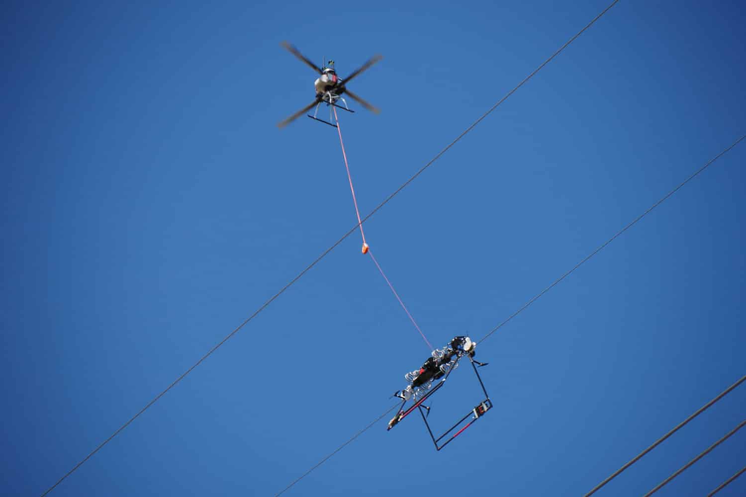 Utility lineworkers utilize the Mini LineFly to install PLP BIRD-FLIGHT Diverters on overhead power lines.