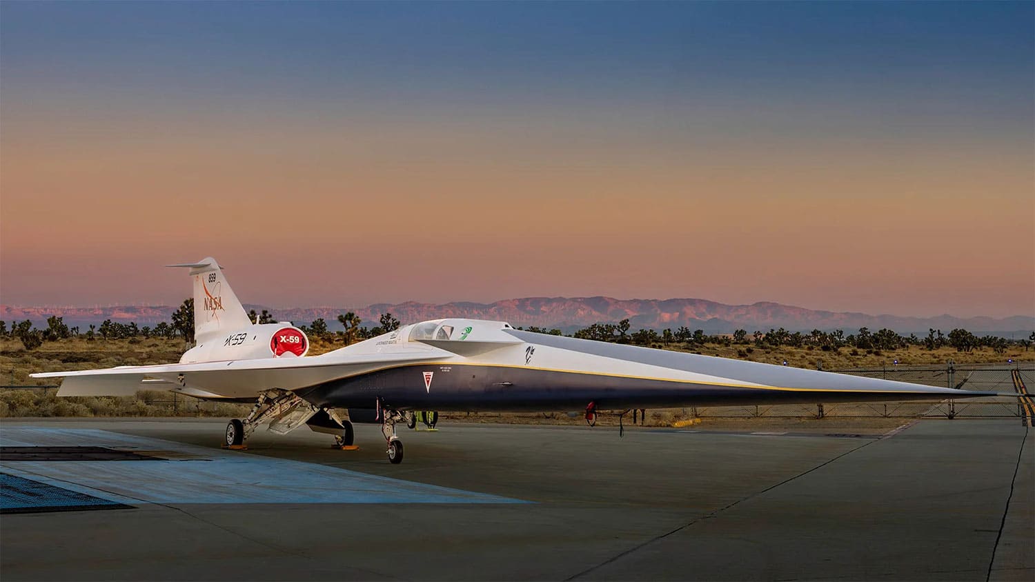NASA’s X-59 quiet supersonic research aircraft sits on the apron outside Lockheed Martin’s Skunk Works facility at dawn in Palmdale, California.