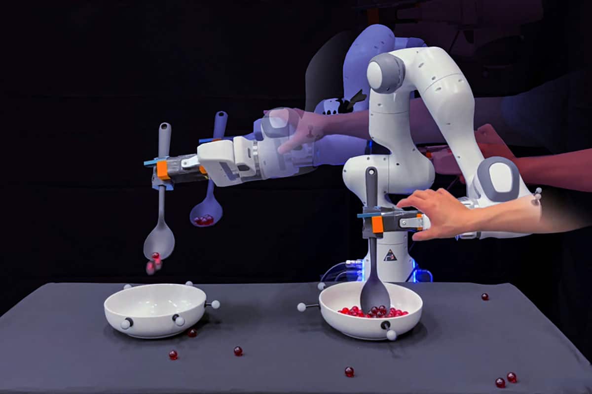 In this collaged image, a robotic hand tries to scoop up red marbles and put them into another bowl while a researcher’s hand frequently disrupts it. The robot eventually succeeds.