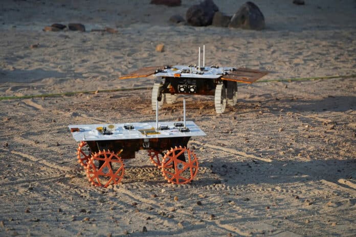 Two full-scale development model rovers are tested in JPL’s Mars Yard in August 2023 as part of NASA’s CADRE tech demo.
