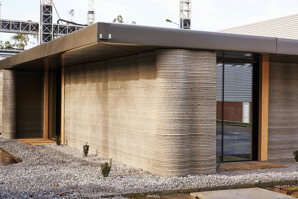A fachada ondulada da primeira casa impressa em 3D de Portugal demonstra a flexibilidade de design incomparável oferecida pela tecnologia de impressão 3D para construção.