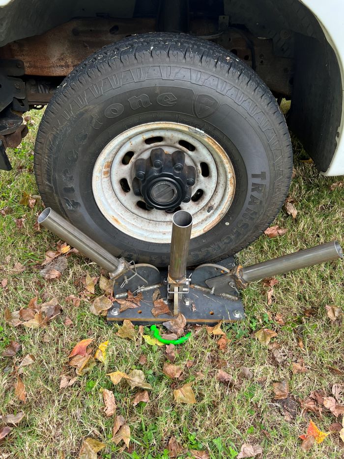 Pole base placed under the vehicle's tire