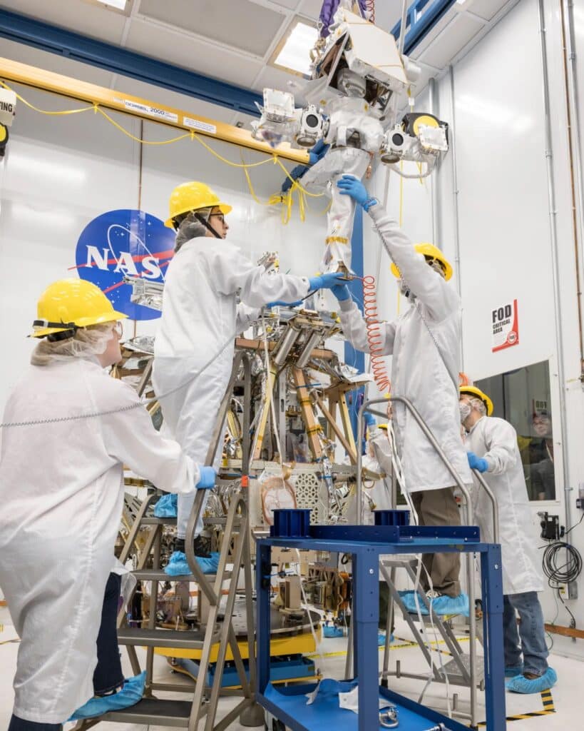 A team of engineers lifts the mast into place atop of NASA’s VIPER robotic Moon rover in a clean room at NASA’s Johnson Space Center in Houston.