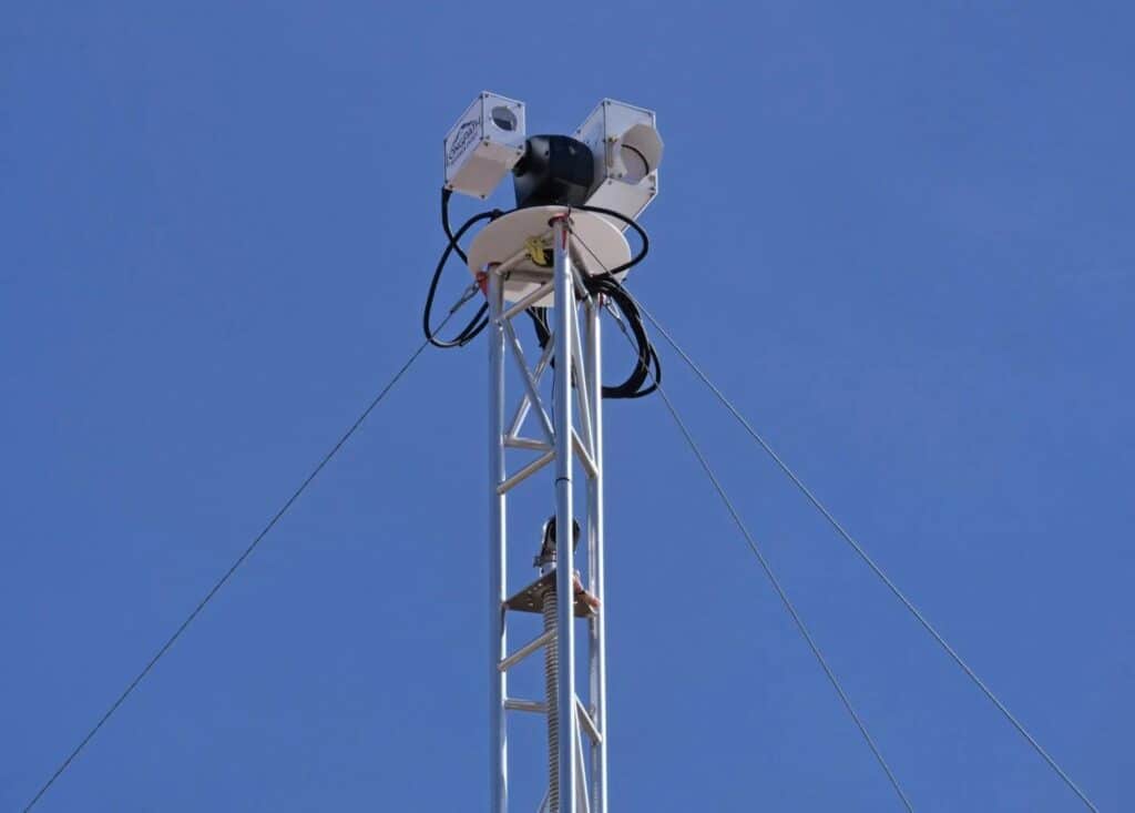 A laser system for detecting methane gas in the air sits on top of a tower at a oil and gas facility in Colorado.
