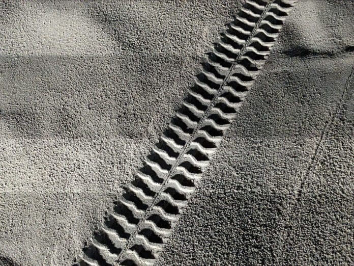 A robotic rover created tread marks in simulated lunar regolith.