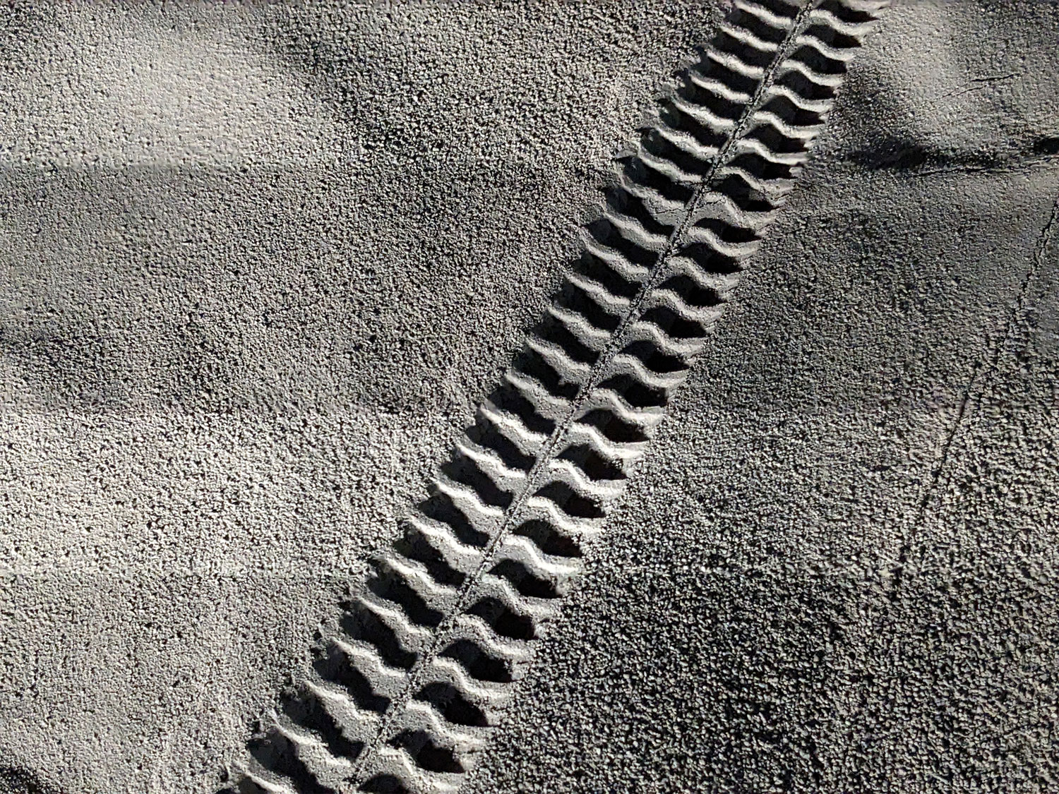 A robotic rover created tread marks in simulated lunar regolith.